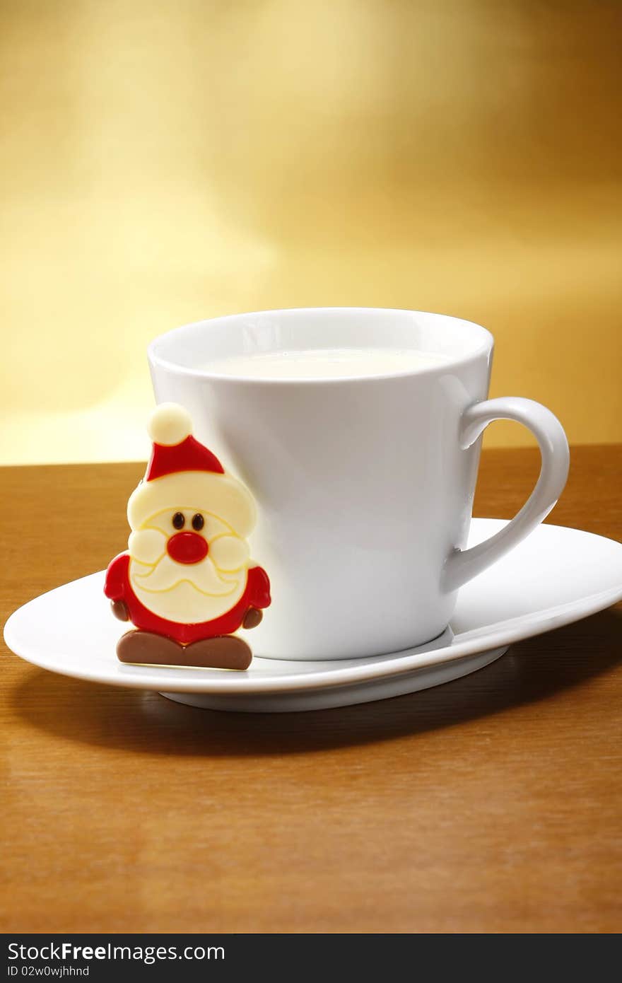 Milk and cookies for santa on table with gold background