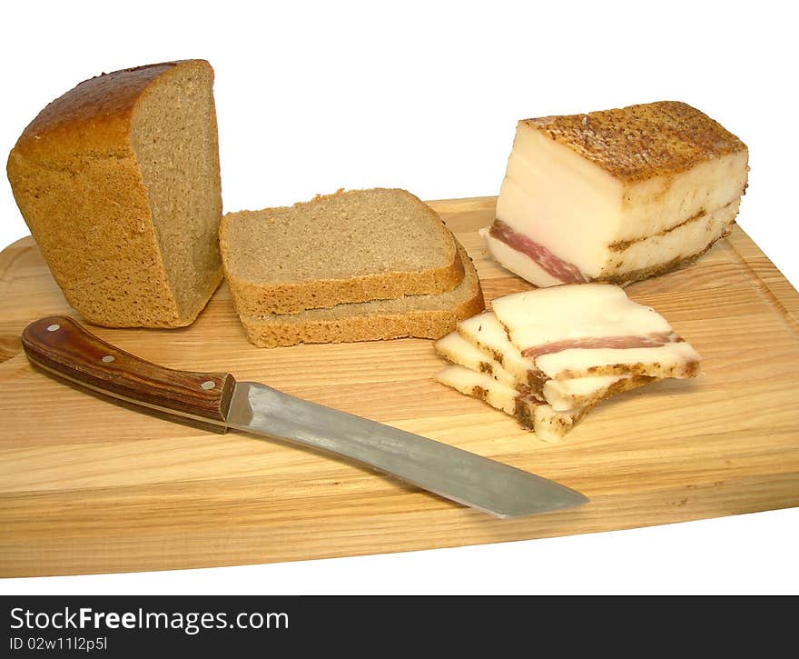 Bread and bacon on a cutting board are shown in the picture. Bread and bacon on a cutting board are shown in the picture.