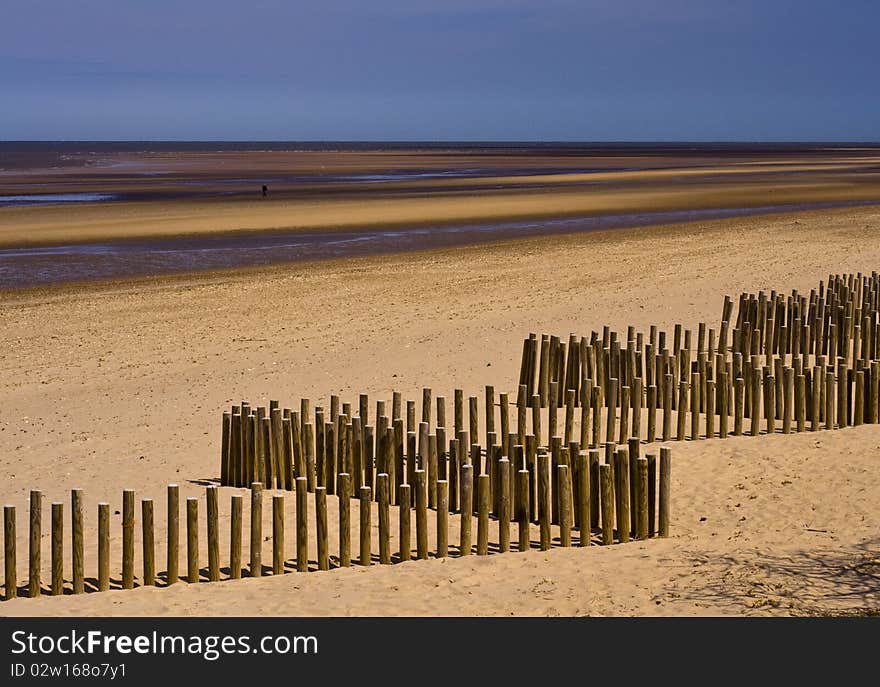 Wooden breakwaters on the beach