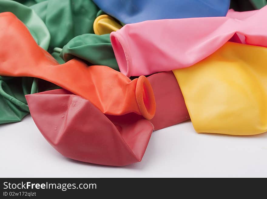 Inflatable balls of different colour from latex on a white background.