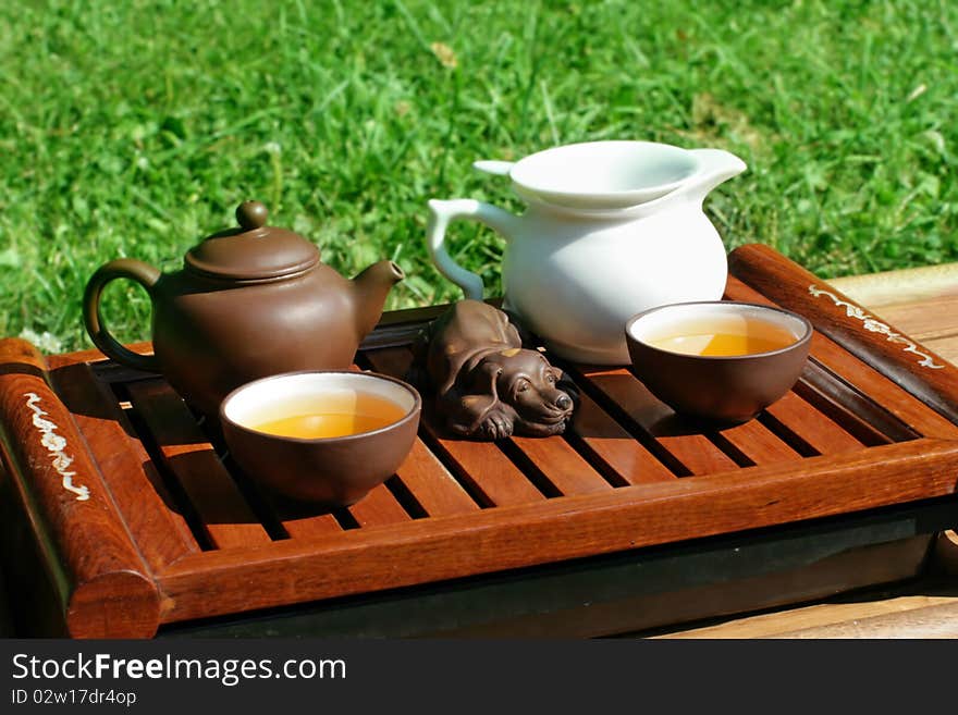 Green tea serving in clay tea pot and two cups