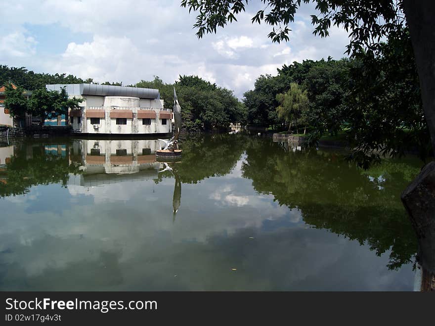 Lakes and buildings, and trees. Shade. Reflection in the water. Beautiful scenery. This is a part of the park in Shenzhen Xin. Lakes and buildings, and trees. Shade. Reflection in the water. Beautiful scenery. This is a part of the park in Shenzhen Xin.