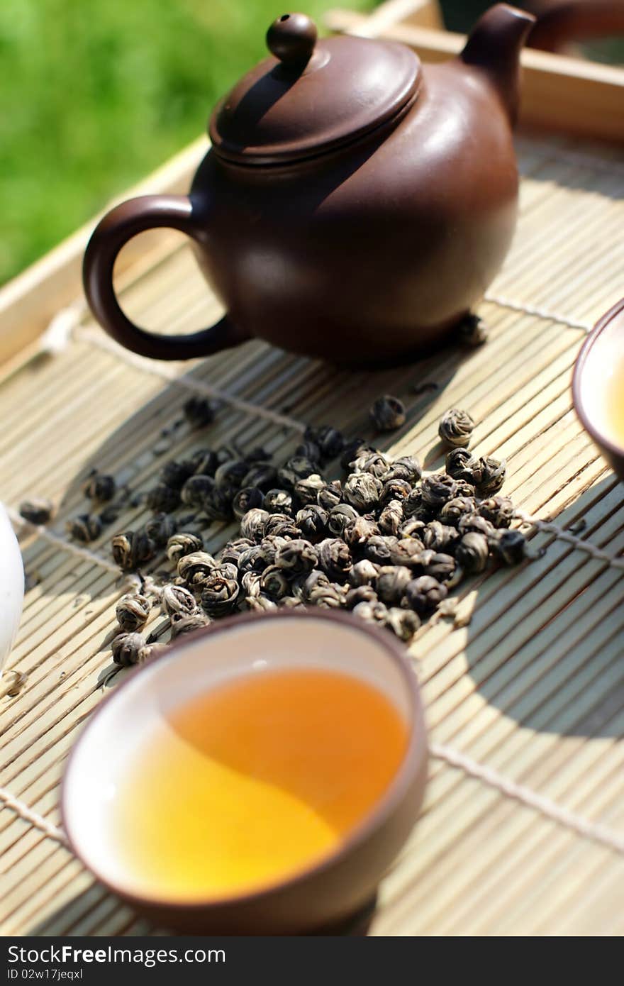 Green tea serving in clay tea pot and cup