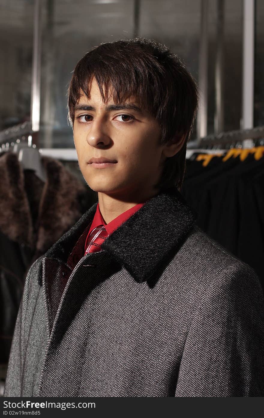 Portrait of a handsome young man of sixteen. Youth shows autumn, winter clothing. Portrait of a handsome young man of sixteen. Youth shows autumn, winter clothing.