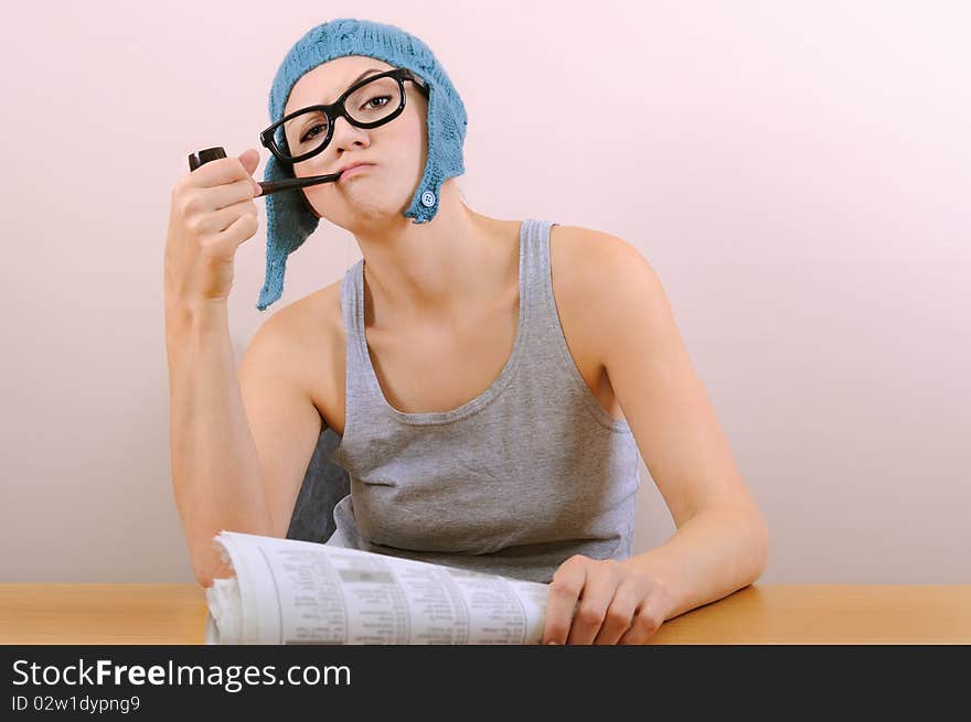 Young woman smoking pipe in studio.