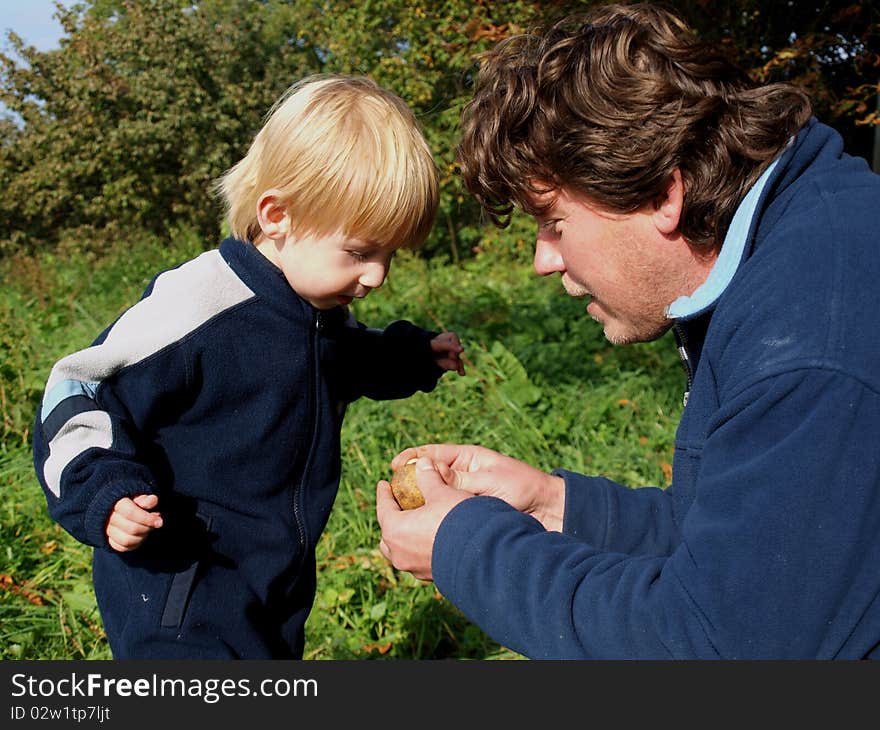 Father teaches son to know nature. Father teaches son to know nature