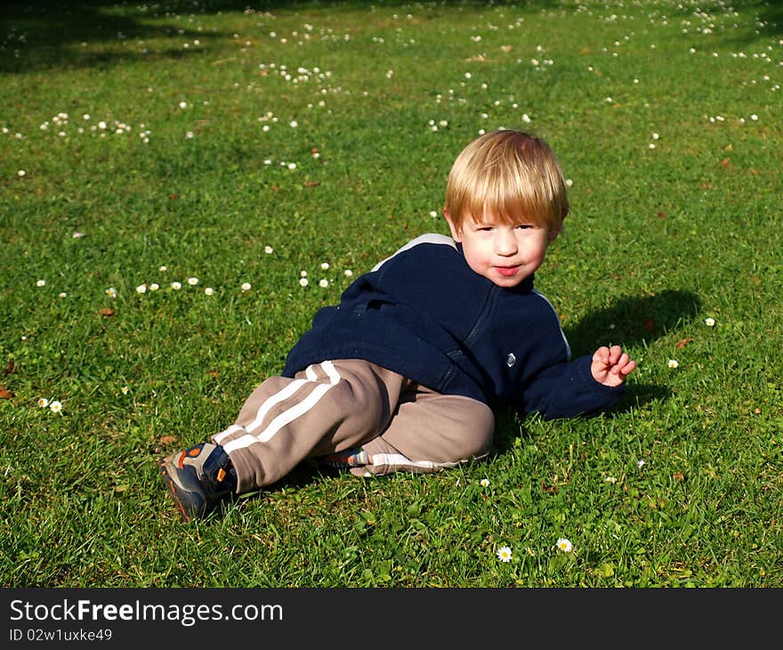 Boy lying on the grass in park