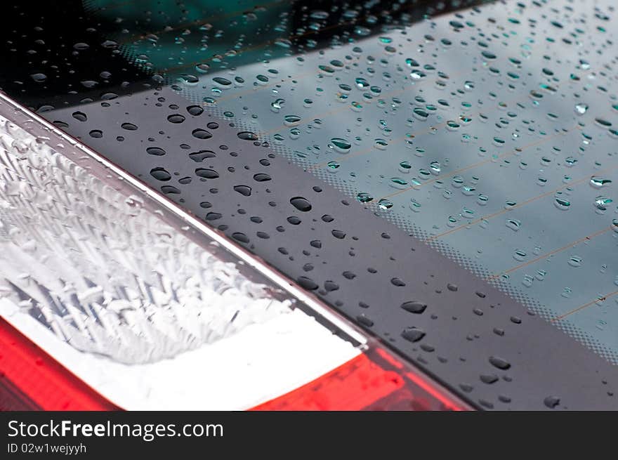 Whater drops on the surface of a blue car