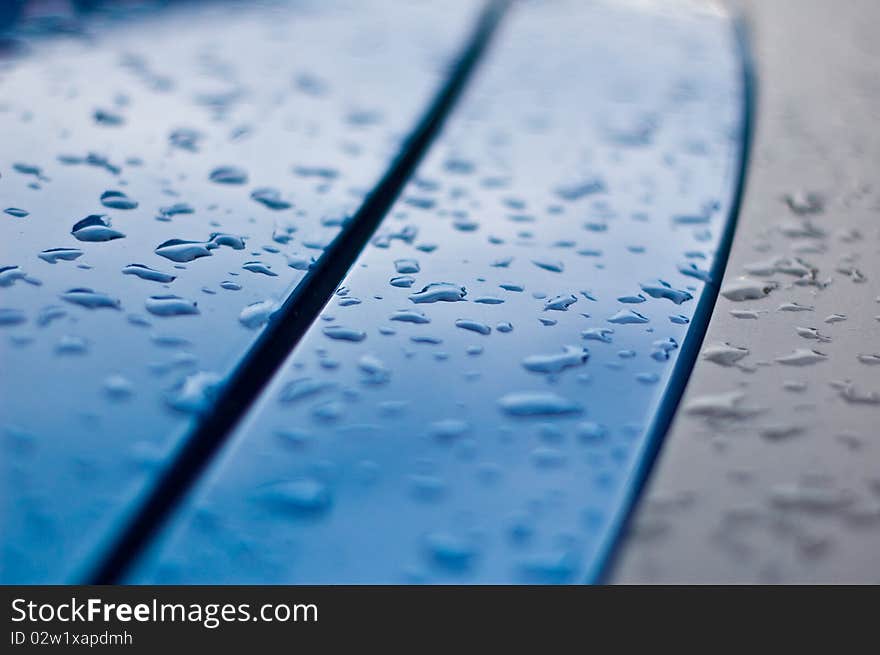 Whater drops on the surface of a blue car