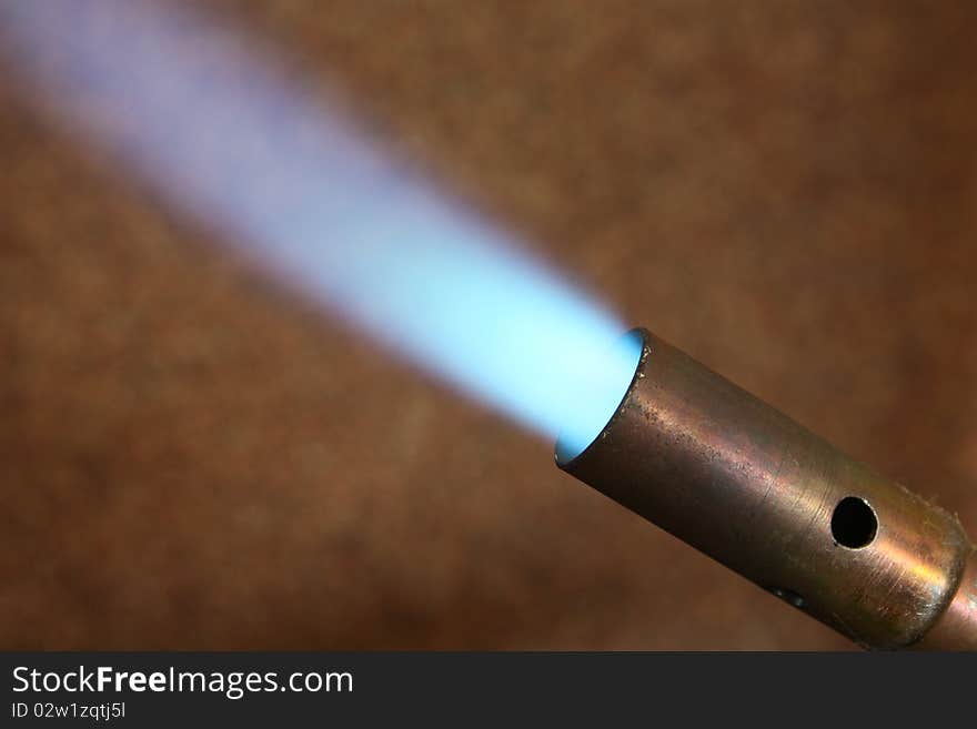 Blue flame on brown background. Blue flame on brown background.