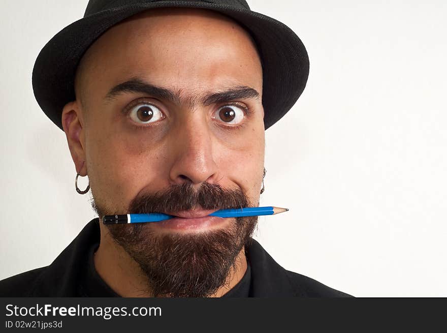 Man with a pencil and a hat with funny expression with white background