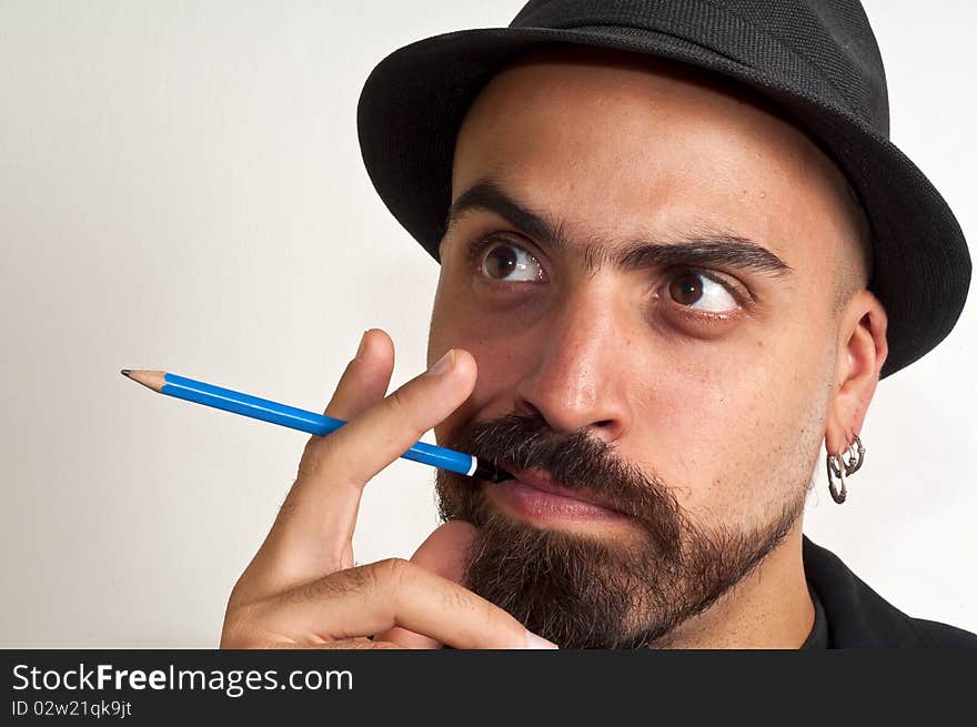 Man with a pencil and a hat with funny expression with white background