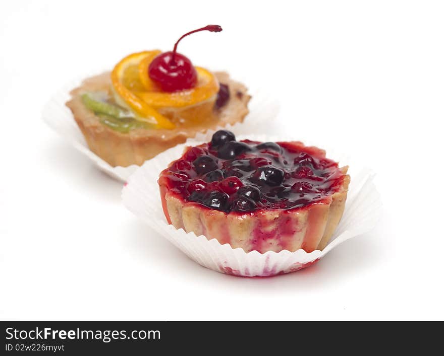 Fruit cupcake with cherry and currants isolated on white