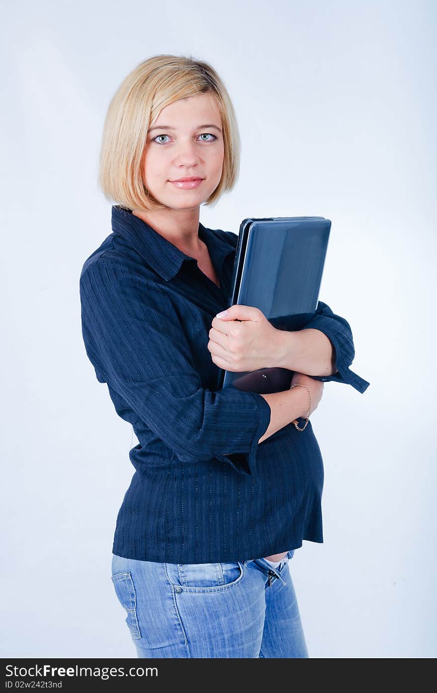 Sweet pregnant girl with a laptop in the studio