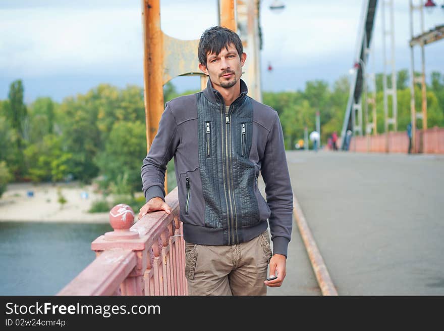 Portrait of a young beautiful man on autumn walk