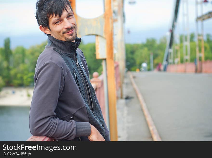 Portrait of a young beautiful man on autumn walk