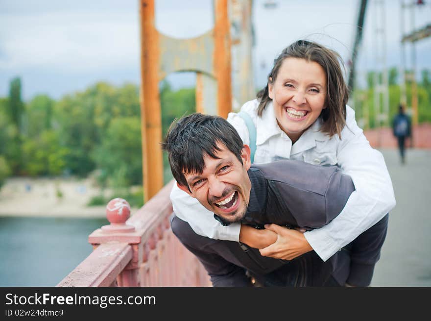 Young beautiful couple having fun in the autumn walk