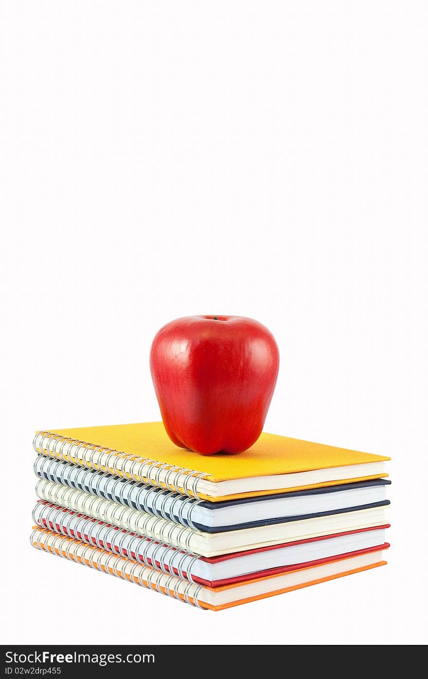 Red Apple Placed On Stack Of Note Book and Isolate On White background