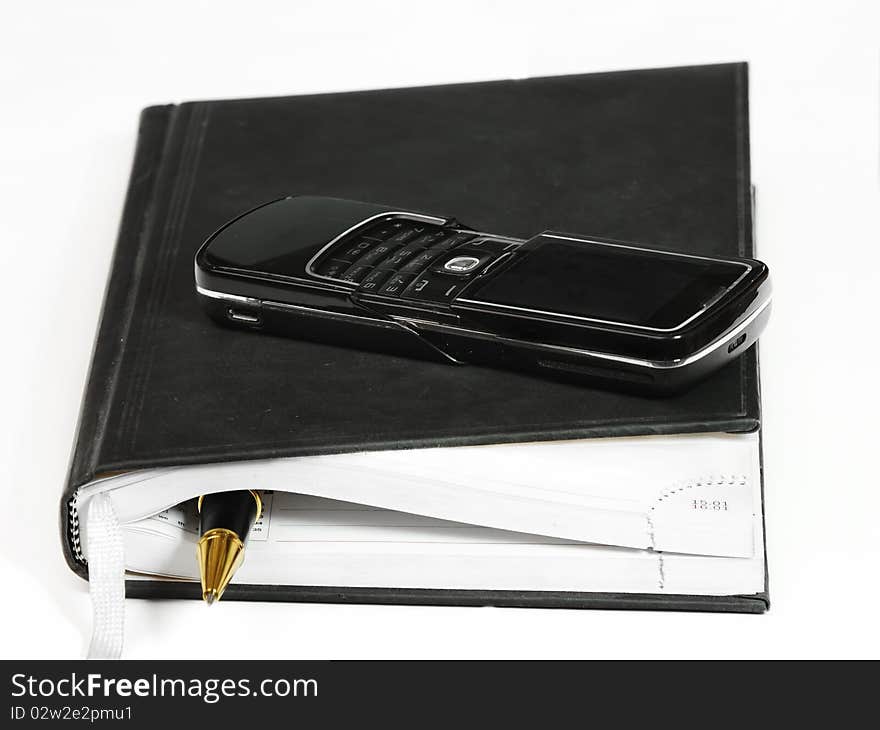 Notebook, phone  and pen for writing notes. Business note concep. Notebook, phone  and pen for writing notes. Business note concep.