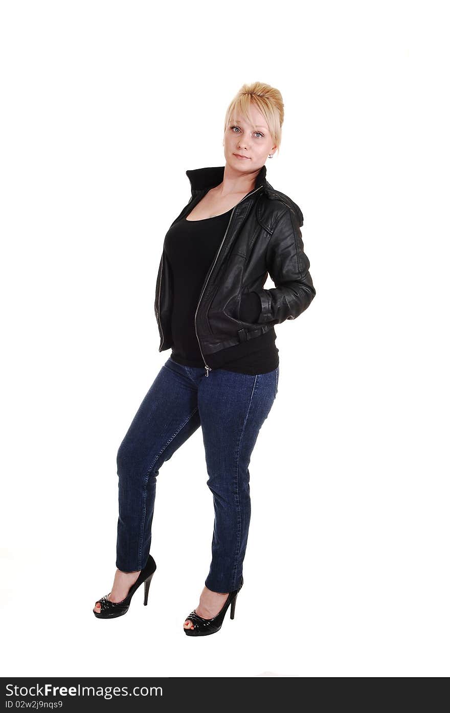 An pretty blond woman in jeans and a black tank top and leather jacket, standing in the studio, for white background. An pretty blond woman in jeans and a black tank top and leather jacket, standing in the studio, for white background.