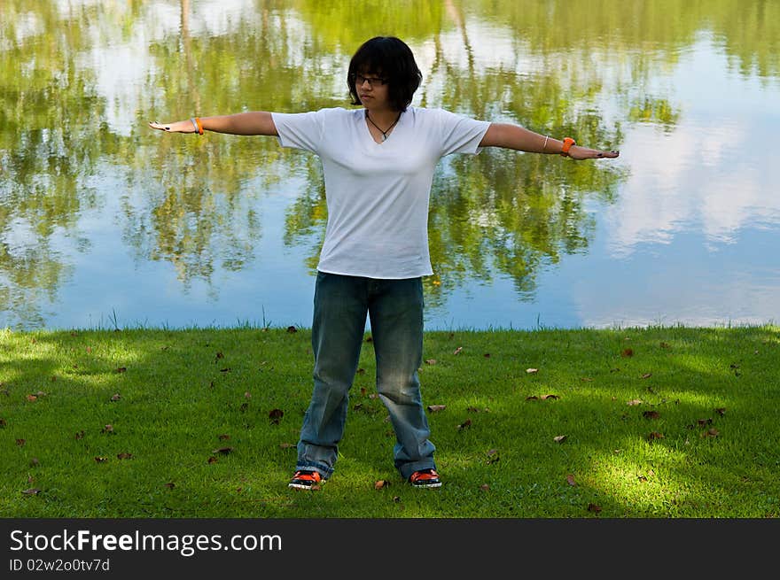 A girl were exercising in the park. A girl were exercising in the park.