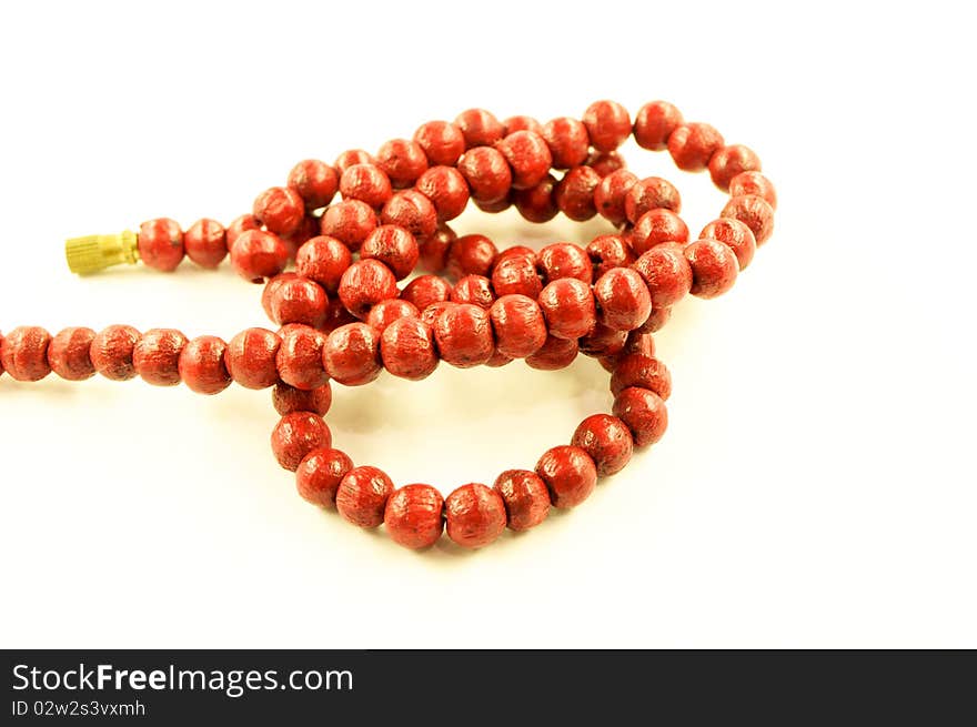 Wooden red necklace on a white background