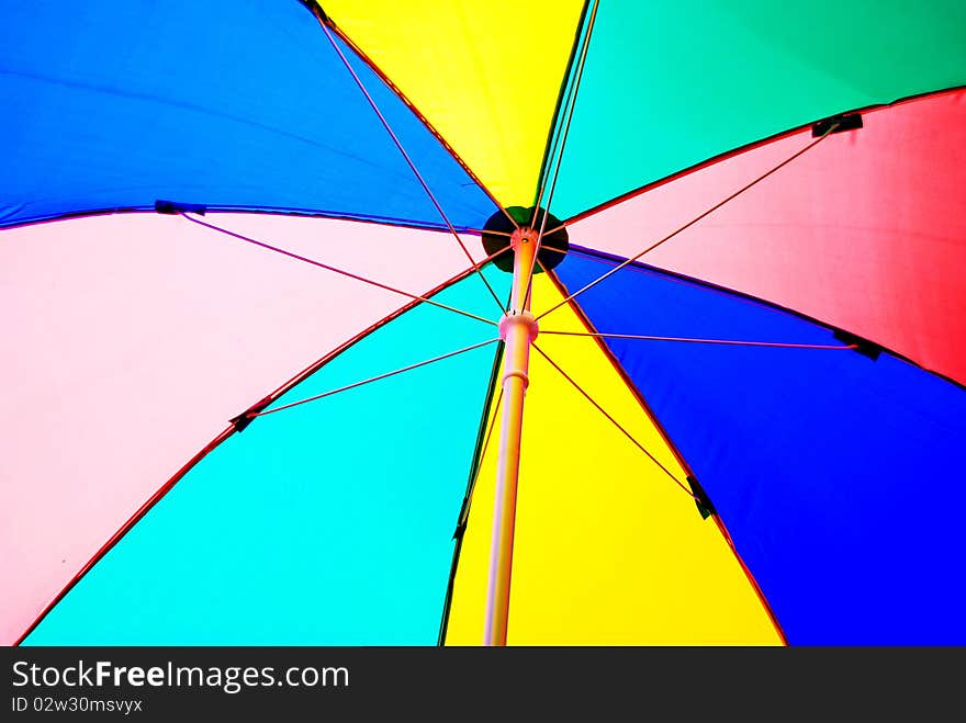 Under colorful beach umbrella