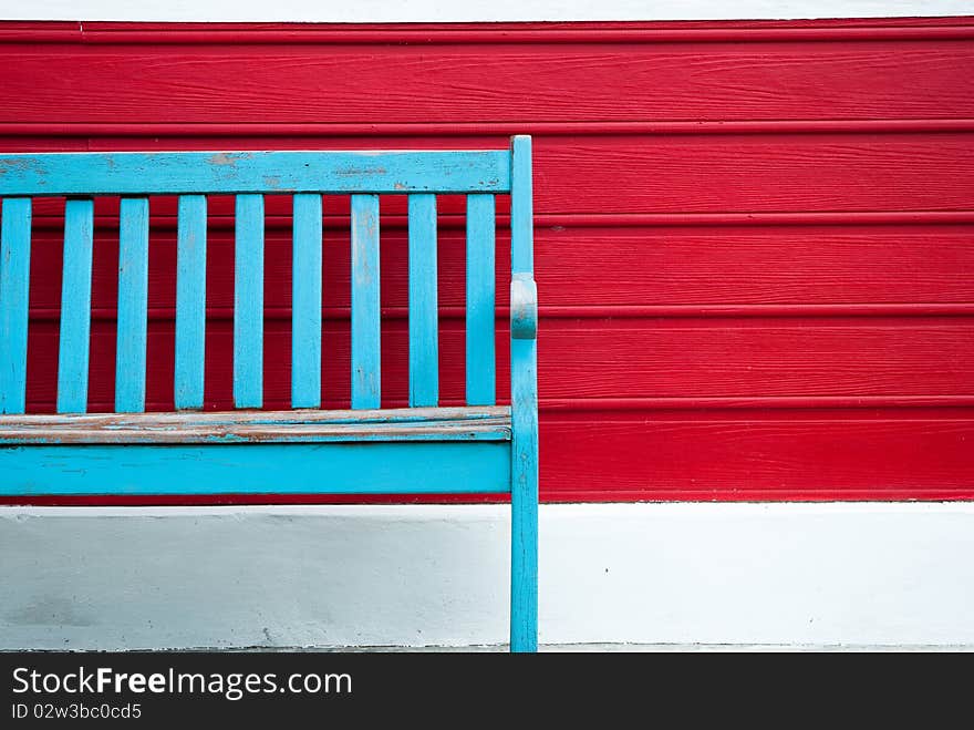 Old bench on red wood wall