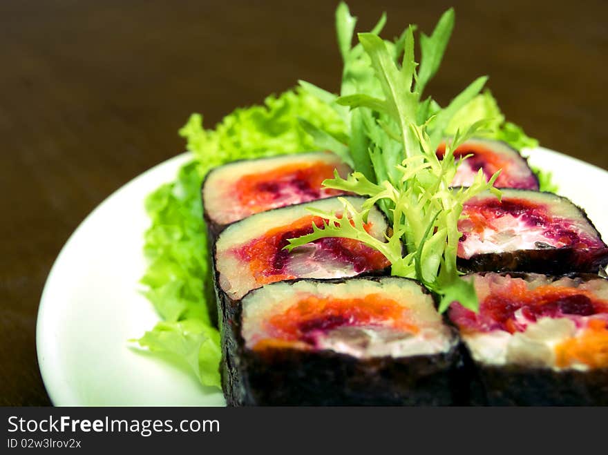 Portion of rolls served with salad on the oval plate