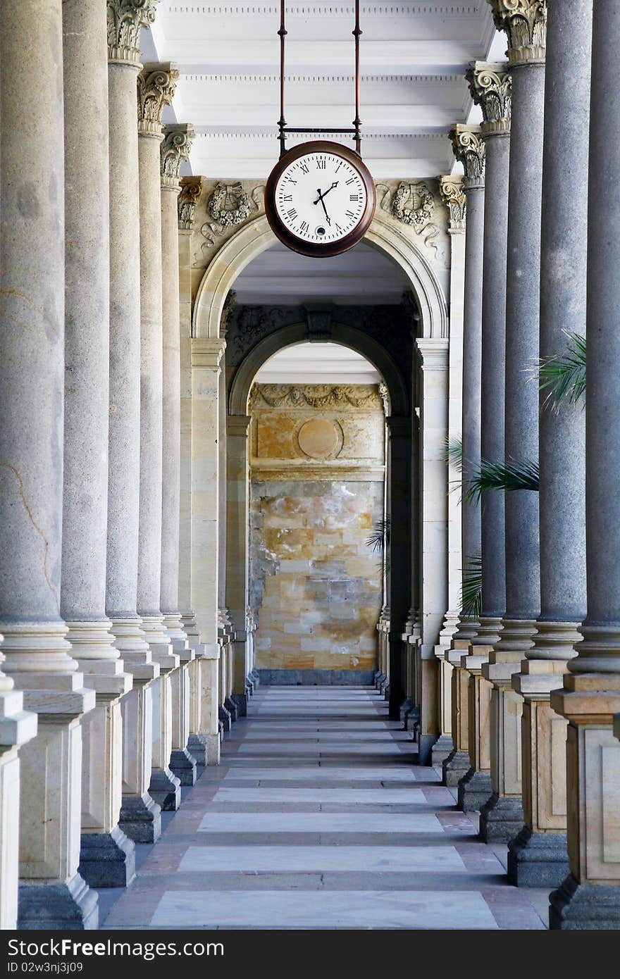 Old style Clock in colonnade