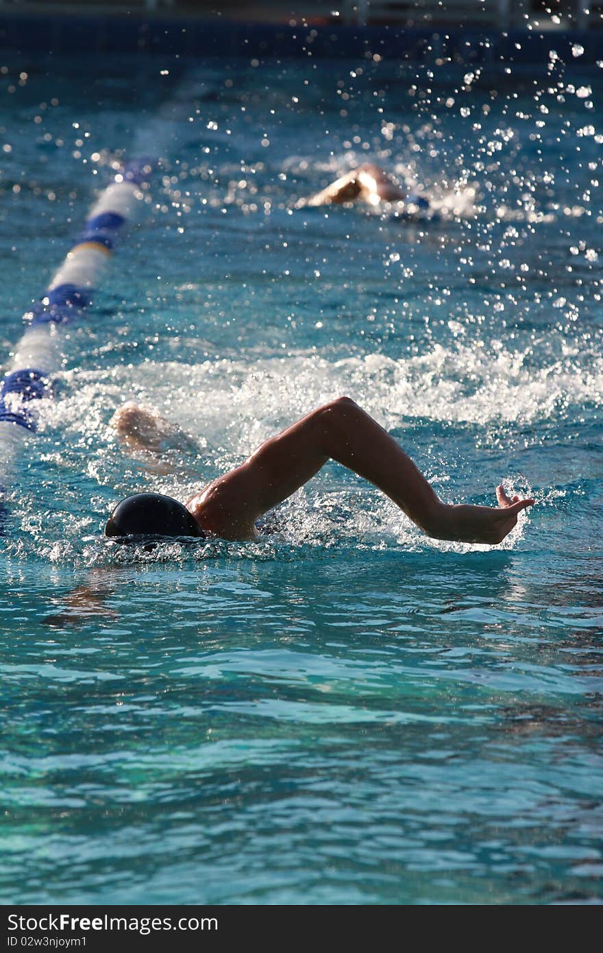 Photo of a swimmers in the pool. Photo of a swimmers in the pool.