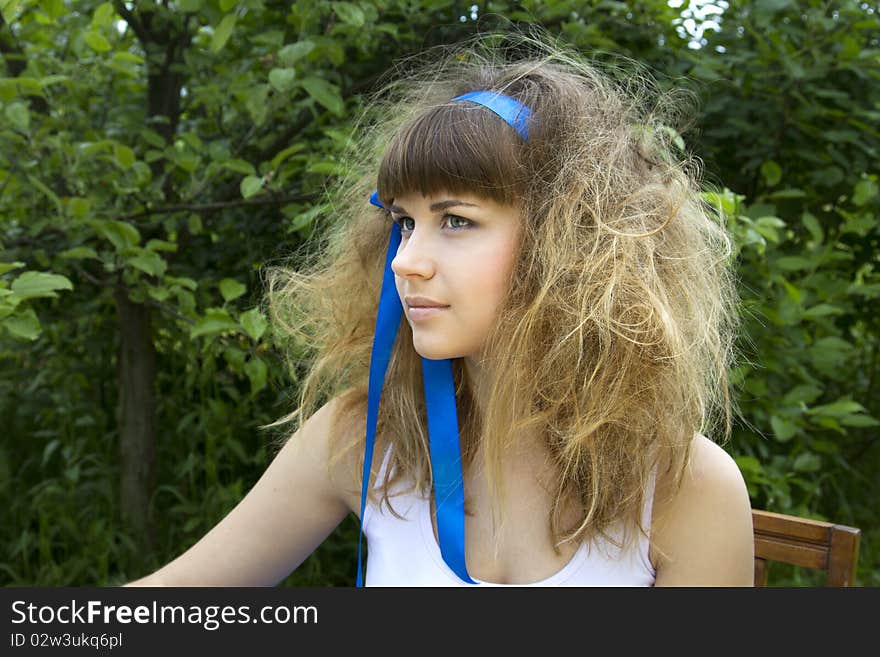 Beautiful girl with the crazy hair in the garden