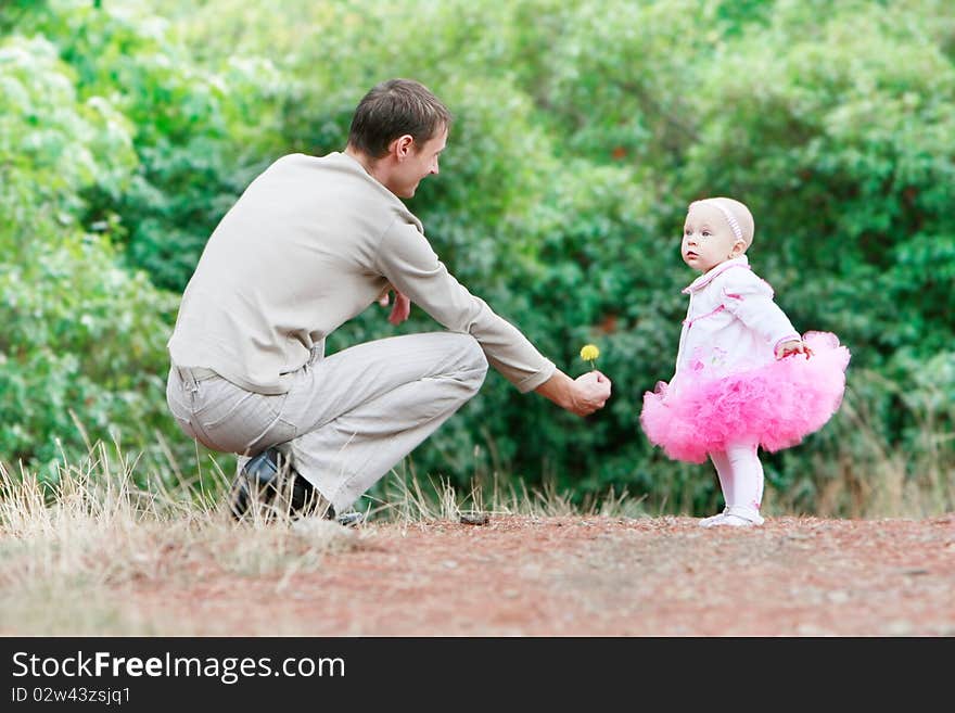 Father giving a flower to daughter