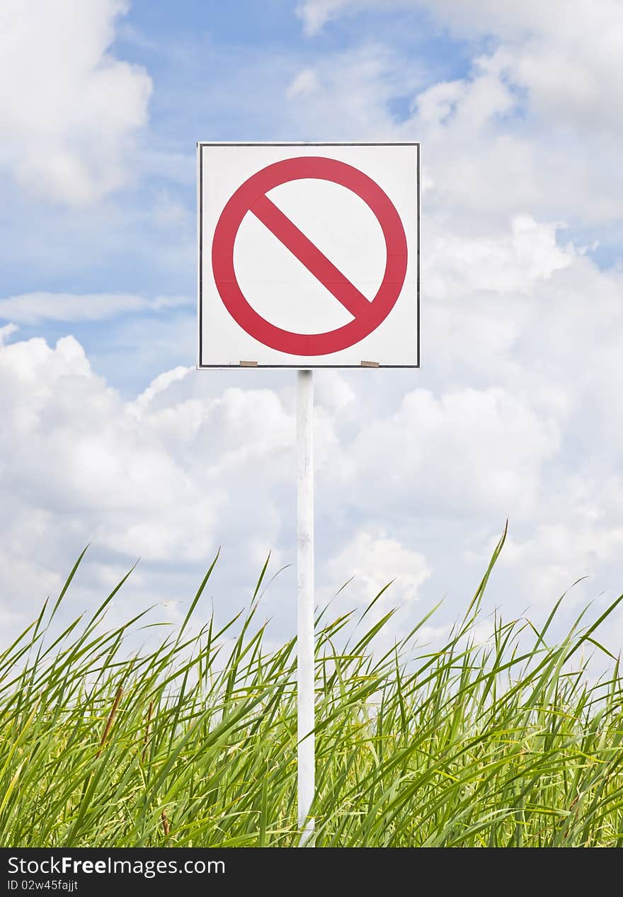 Sign no-pass on grass and sky background. Sign no-pass on grass and sky background