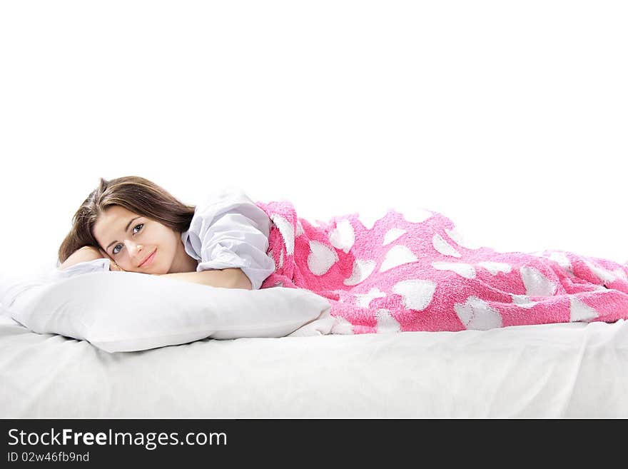 Studio shot of young beautiful woman in bed