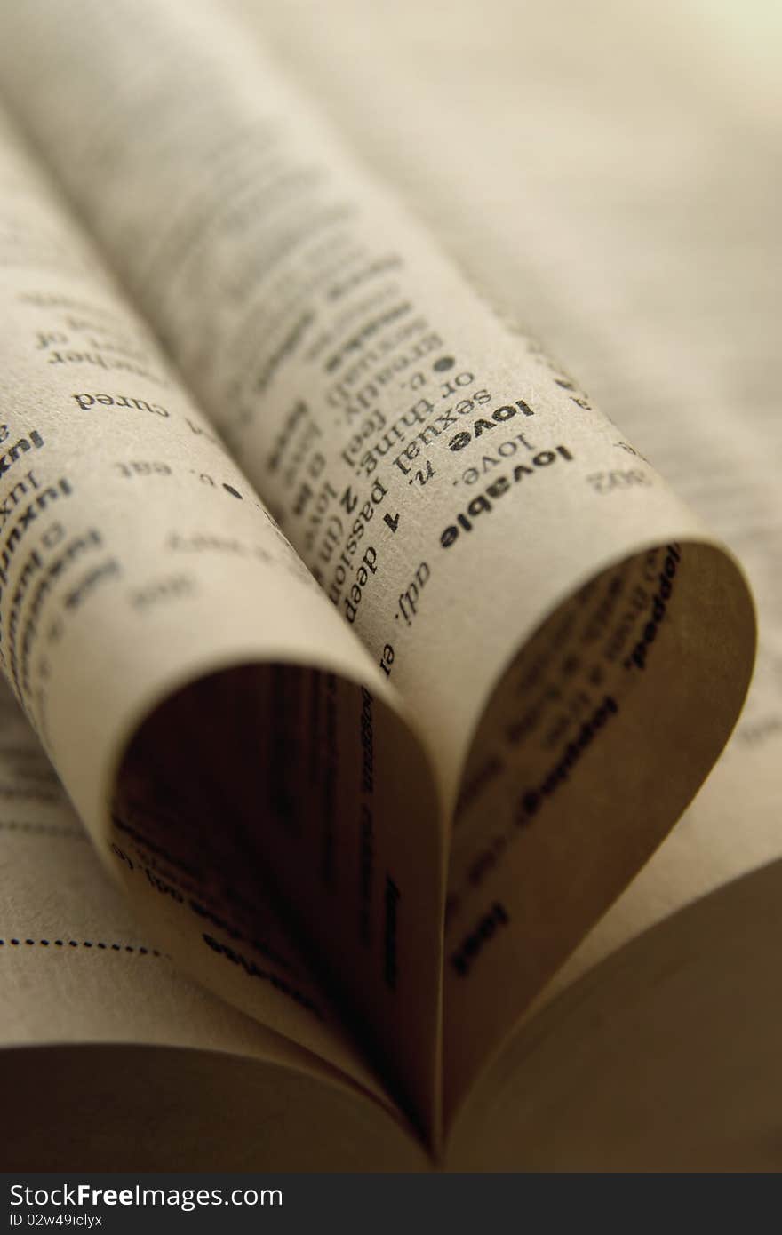 Image shows close up of heart made of rolled up book's sheets