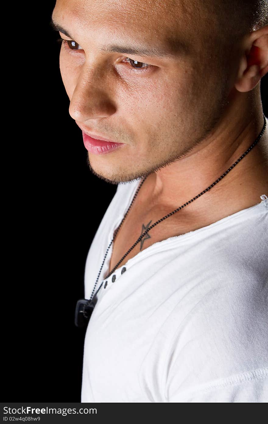 Handsome young male filipino model with white shirt over black background. Handsome young male filipino model with white shirt over black background.