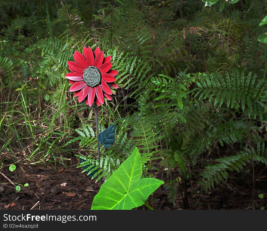 HRD photo image of a red fake flower in the forest. HRD photo image of a red fake flower in the forest