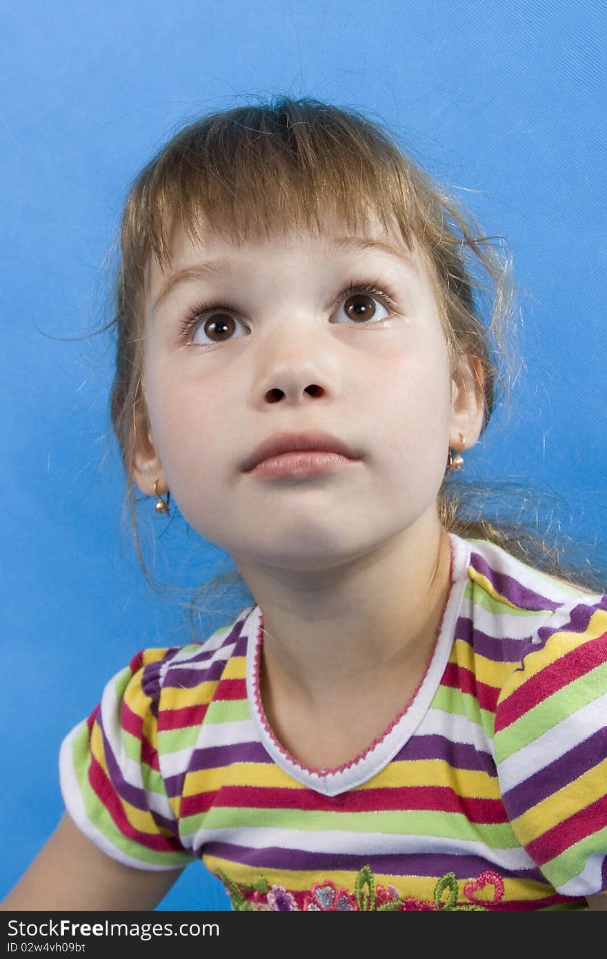 Serious girl looks upwards