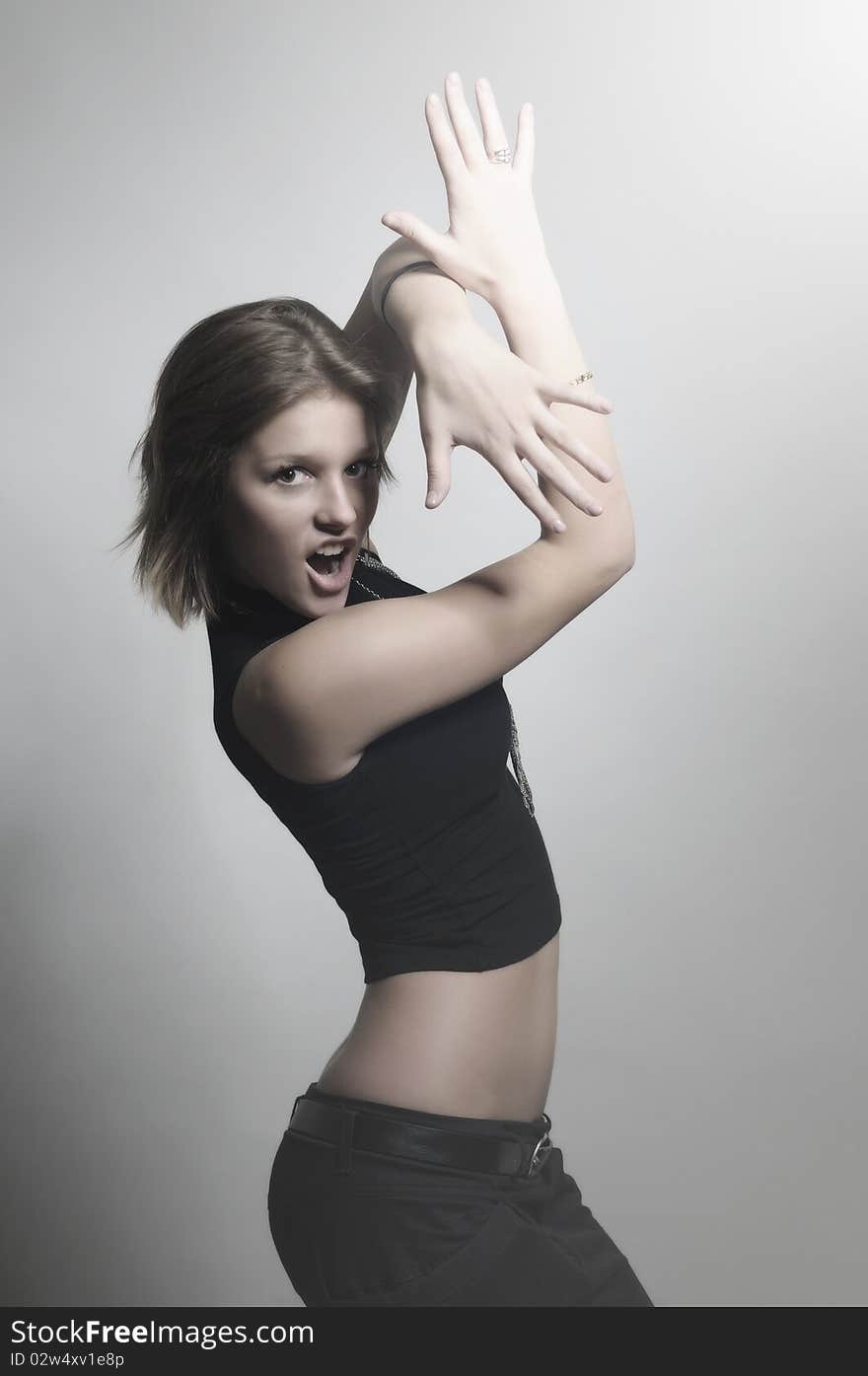 Young contemporary emotional woman in dark clothing and jewelry gesticulating hands, showing ten fingers. light background. Young contemporary emotional woman in dark clothing and jewelry gesticulating hands, showing ten fingers. light background.