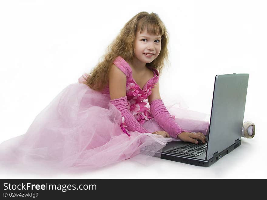 Little girl the princess plays with the notebook. White background. Little girl the princess plays with the notebook. White background