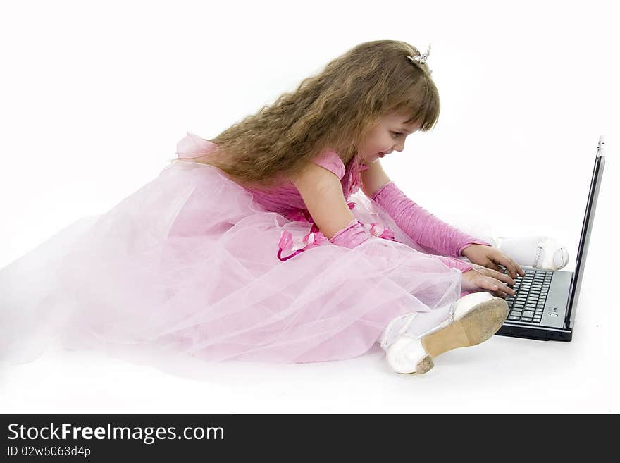 Little girl the princess plays with the notebook. White background. Little girl the princess plays with the notebook. White background