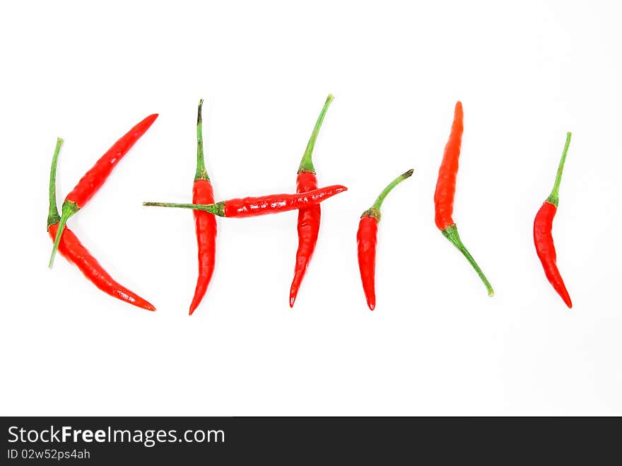 Letter made from red hot chili peppers isolated on seamless white background