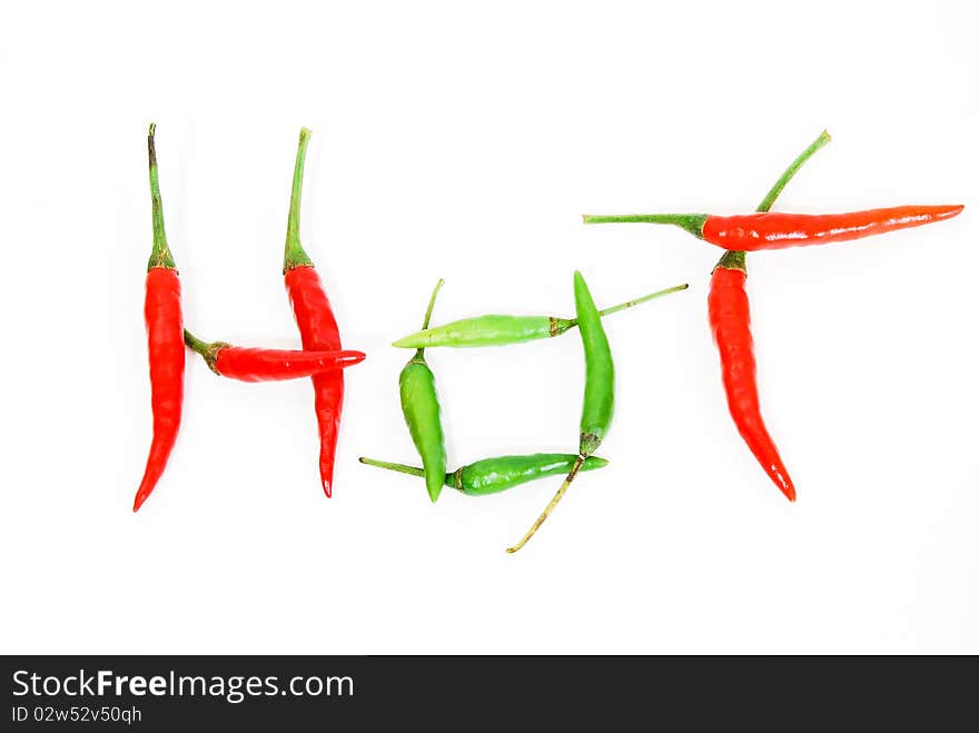 Letter made from red hot chili peppers isolated on seamless white background