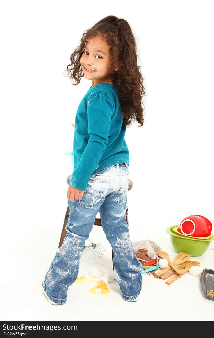 Adorable 3 year old Hispanic-African American girl, baking cookies over white background. Adorable 3 year old Hispanic-African American girl, baking cookies over white background.