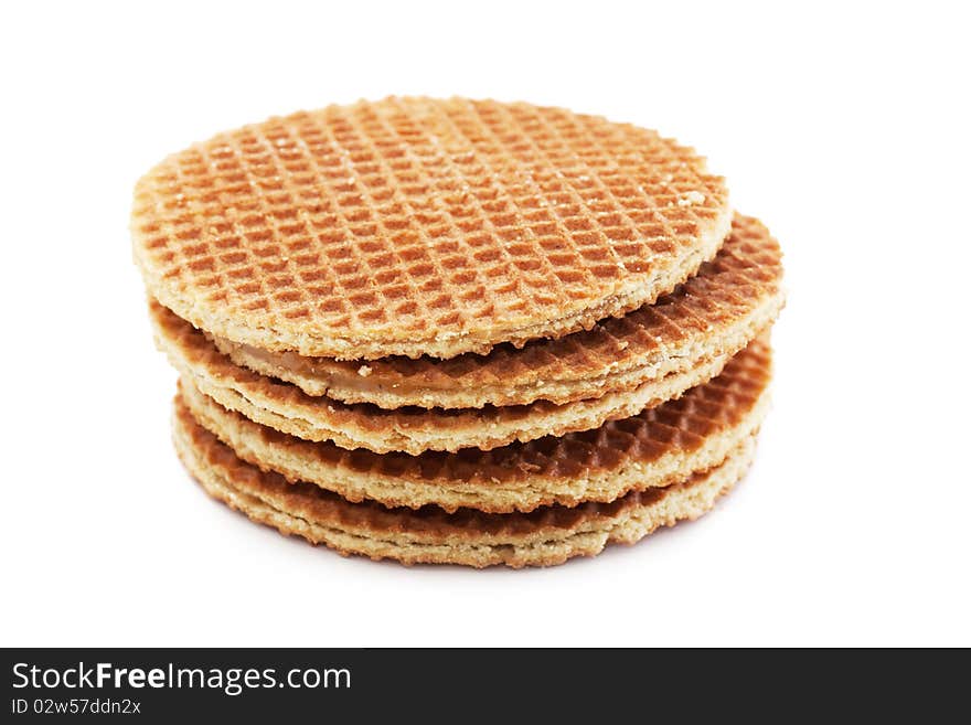 A stack of golden round waffles isolated over white background.