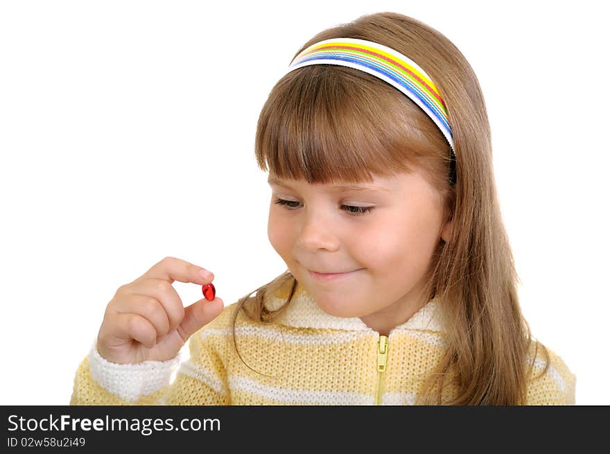 The smiling girl holds a medicinal capsule in a hand on white. The smiling girl holds a medicinal capsule in a hand on white