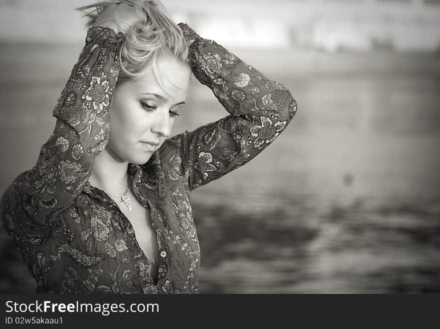 Portrait of a beautiful woman on the background of water . Portrait of a beautiful woman on the background of water ...