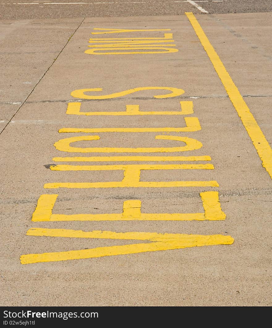 An image of a sign indicating ' vehicles only ' on the road outside a supermarket. An image of a sign indicating ' vehicles only ' on the road outside a supermarket.