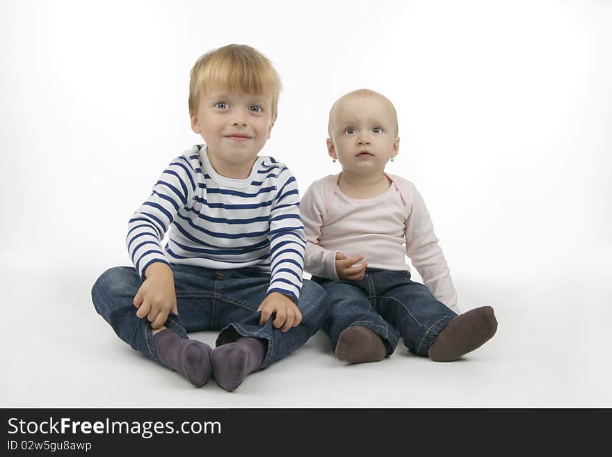 Brothers and sisters sit, on white background.